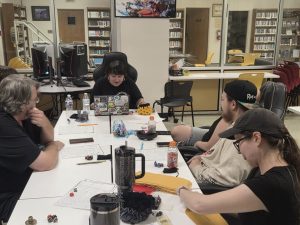 Students sit at a table in the Stanley Library's LEaP studio planning their next move in Call of Cthuhlu