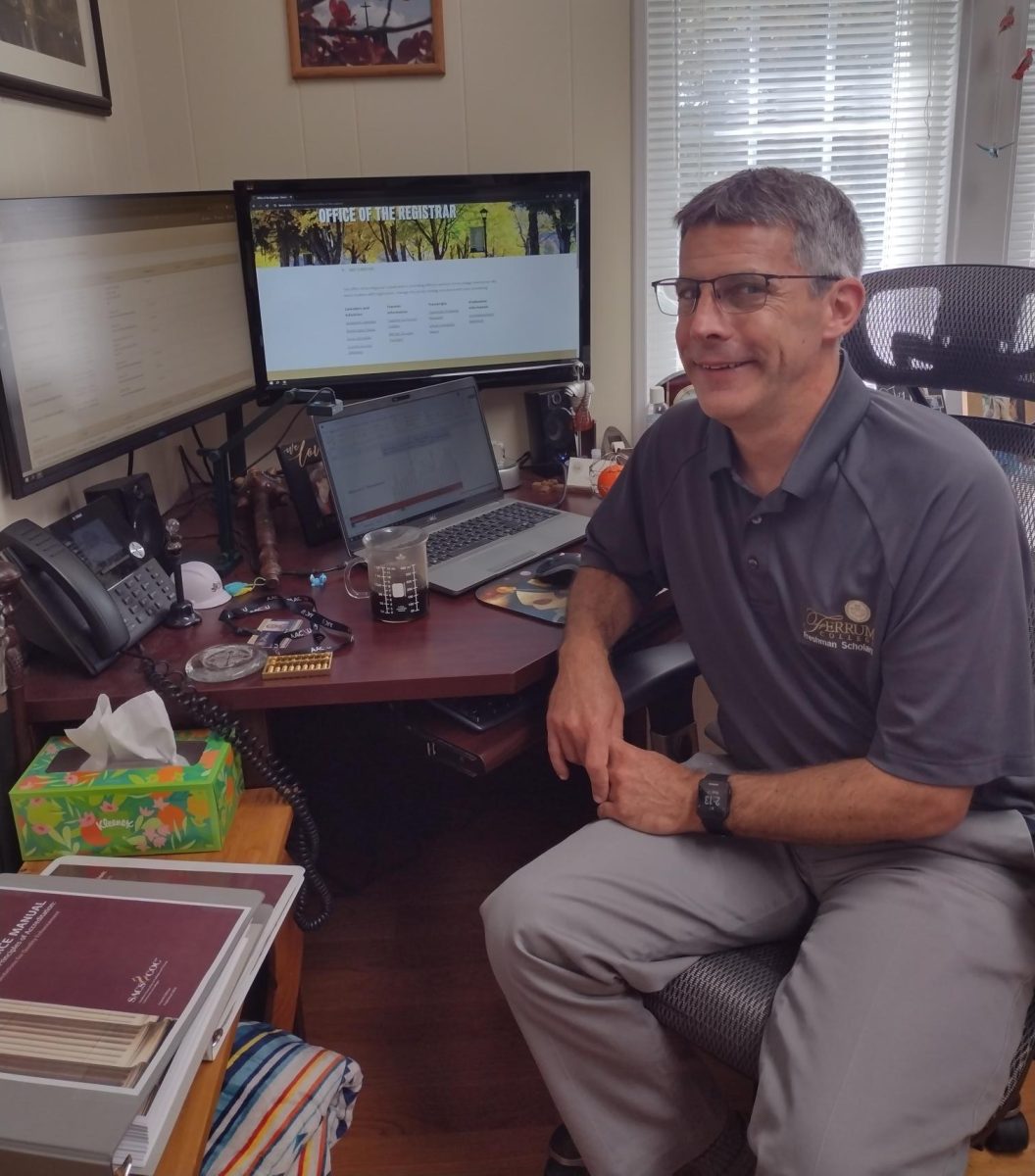 Vice President of Academic Affairs, Jason Powell, enjoys some coffee while working at his desk.