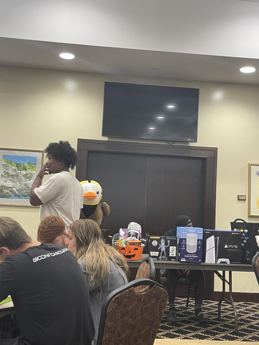 Students wait for bingo night to begin in the Blue Ridge Mountain Room with a prize table loaded for the first winner.
