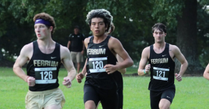 First-years Seth Truett, Guillermo Basurto, and Jesse Earp warm up before an 8k race at the Lancer Pink Invitational.