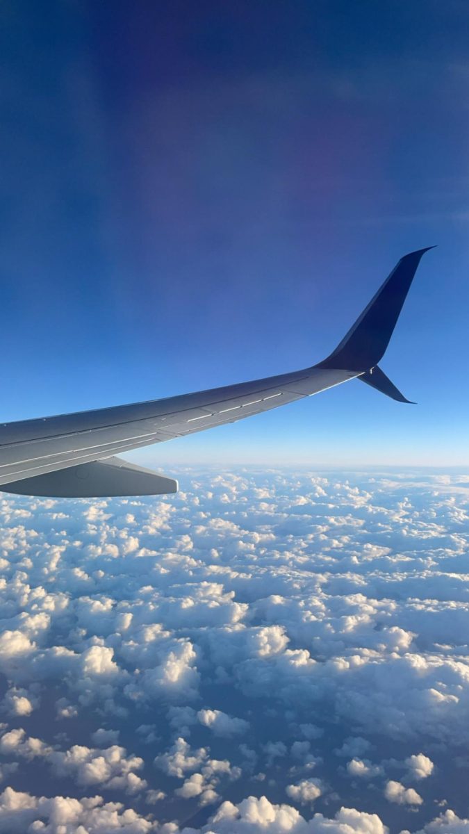 The wing of Delta Airlines jet slices through clouds, revealing endless sky beyond, creating its own experience on the way to the destination.