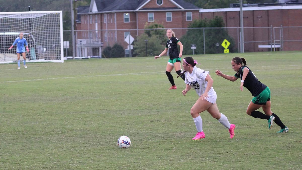 First-year forward Jaden Heirs dribbles away from a defender.
