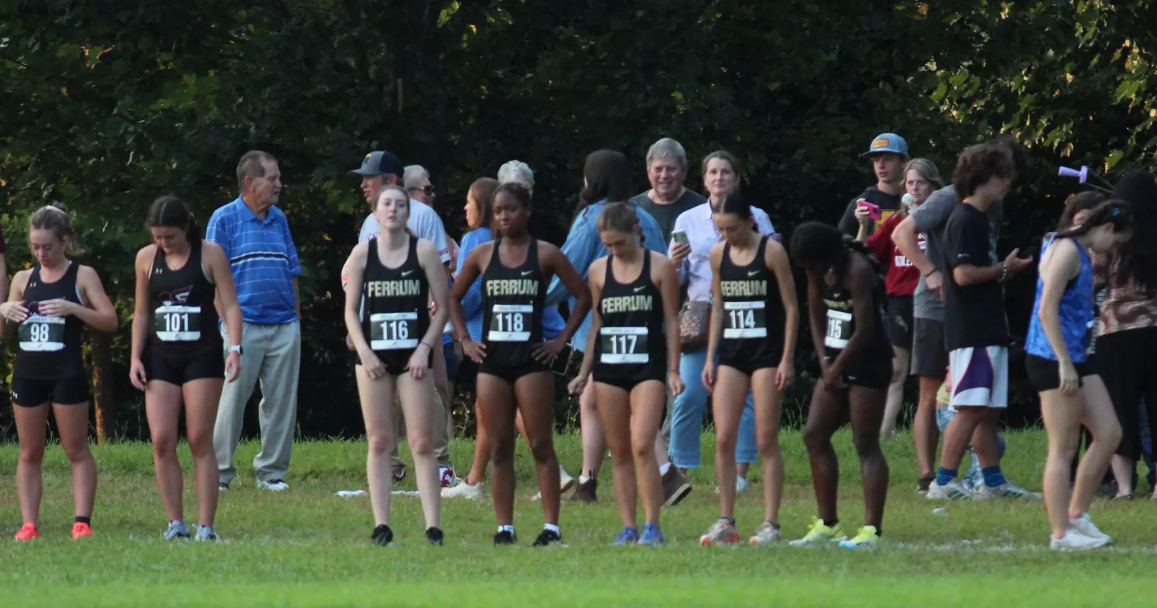 The women's cross country team prepares for their upcoming 5000 meter race at Queens University.
