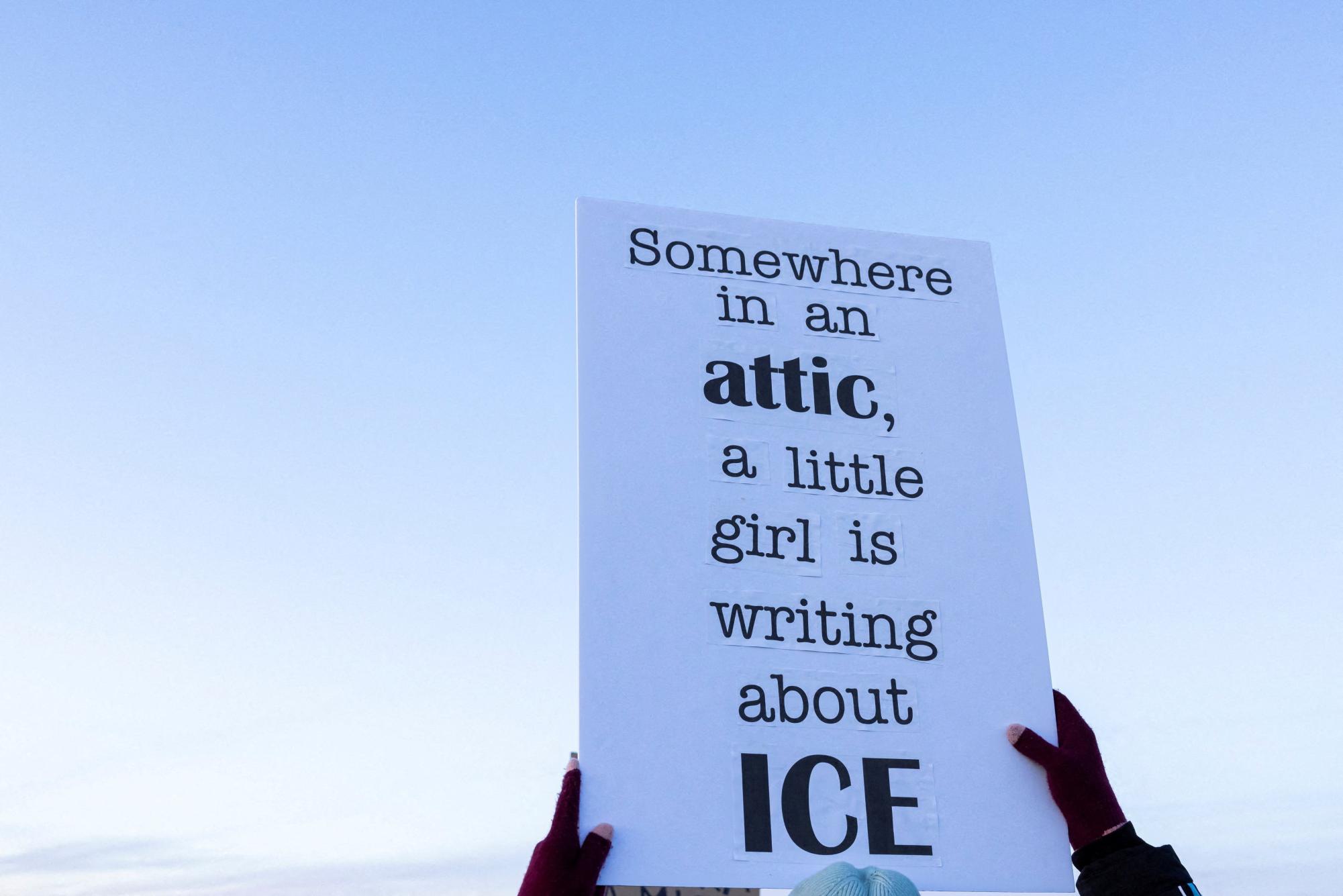 A person raises a sign in protest agains U.S. Customs Enforcement and Immigration (ICE) during a demonstration outside a dormant prison that is under contract to become an ICE detention center in Hudson, Colorado, U.S., January 21, 2026. REUTERS/Kevin Mohatt