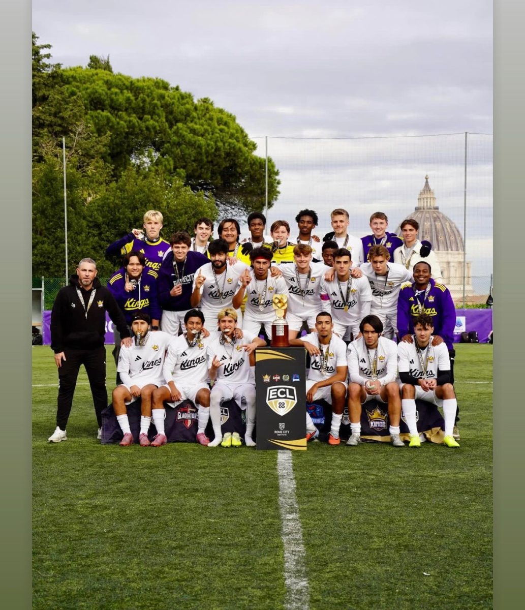 Erick Nolasco stands with his Rome City Team for the 2025 Fall Men's Champions. 