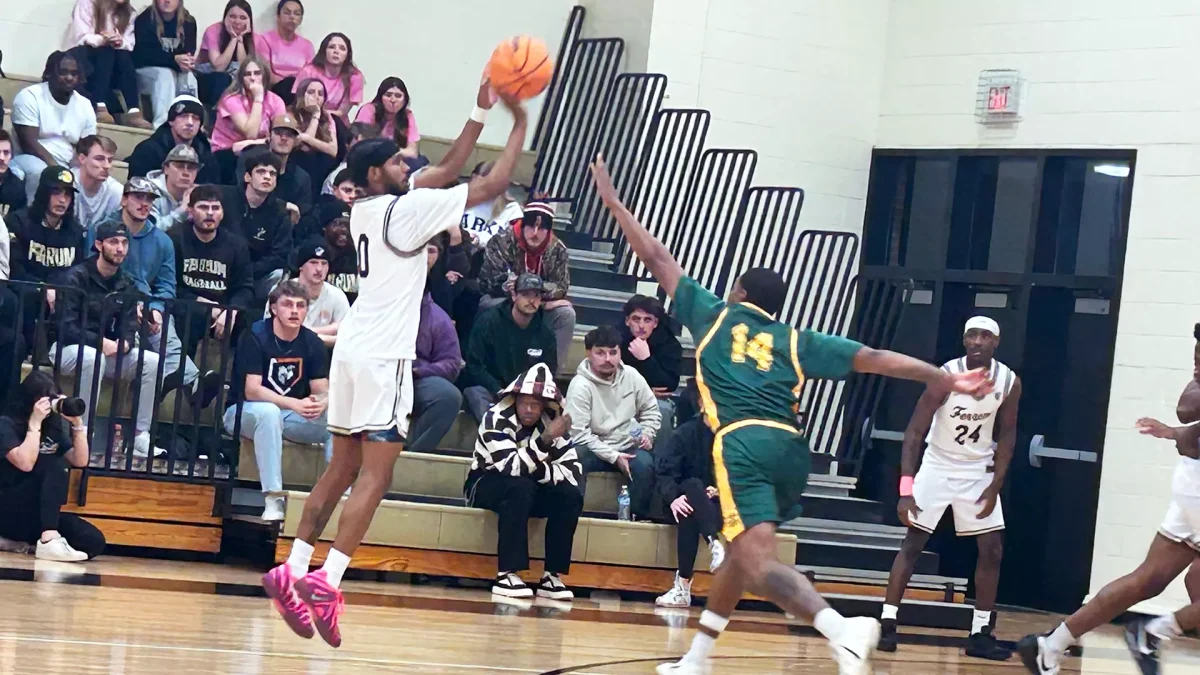 Rodrigo Farias, sophomore, shoots for three over a Lees McRae defender. 