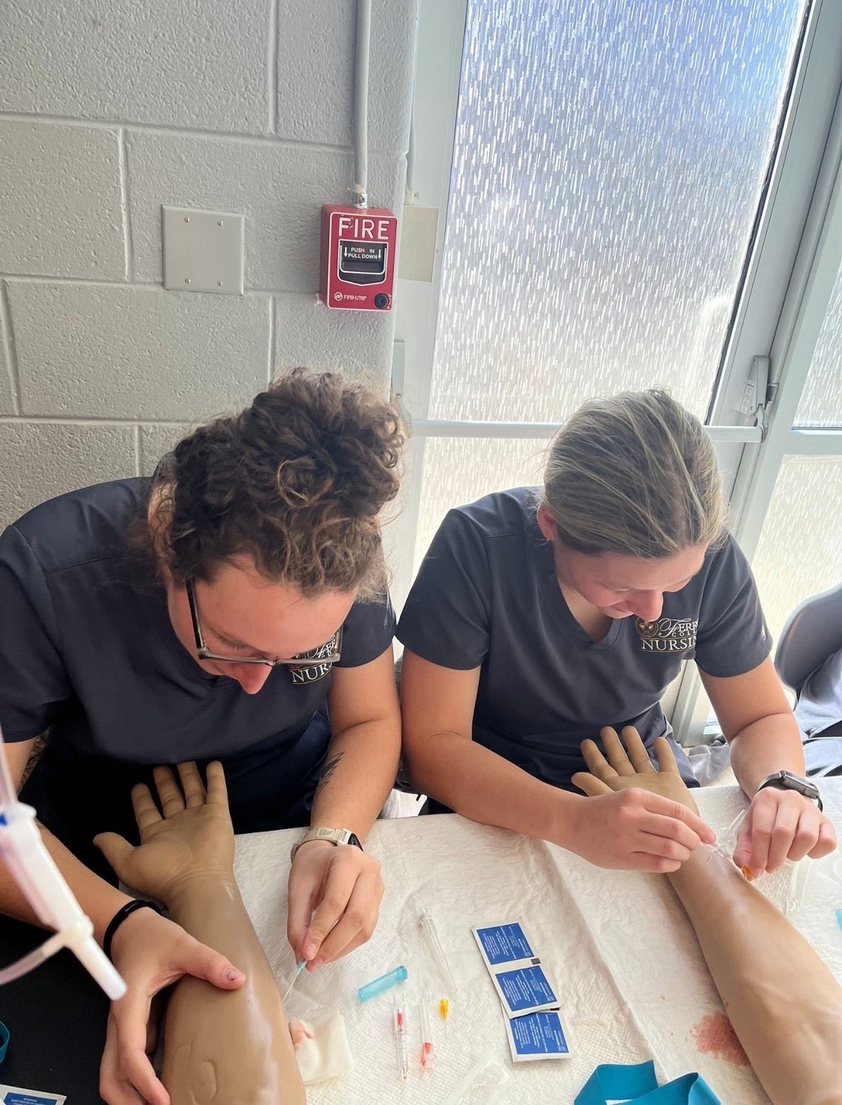 Junior Riley Young, left, practices clinical skills in the lab while balancing her nursing responsibilities with her role on the softball team.