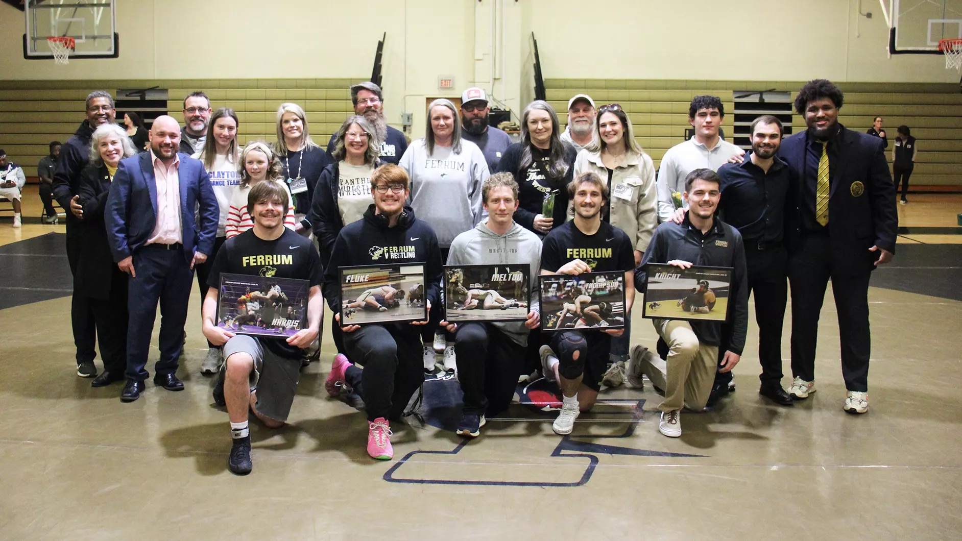 Wrestling's seniors and their families gather for a photo on Senior Night