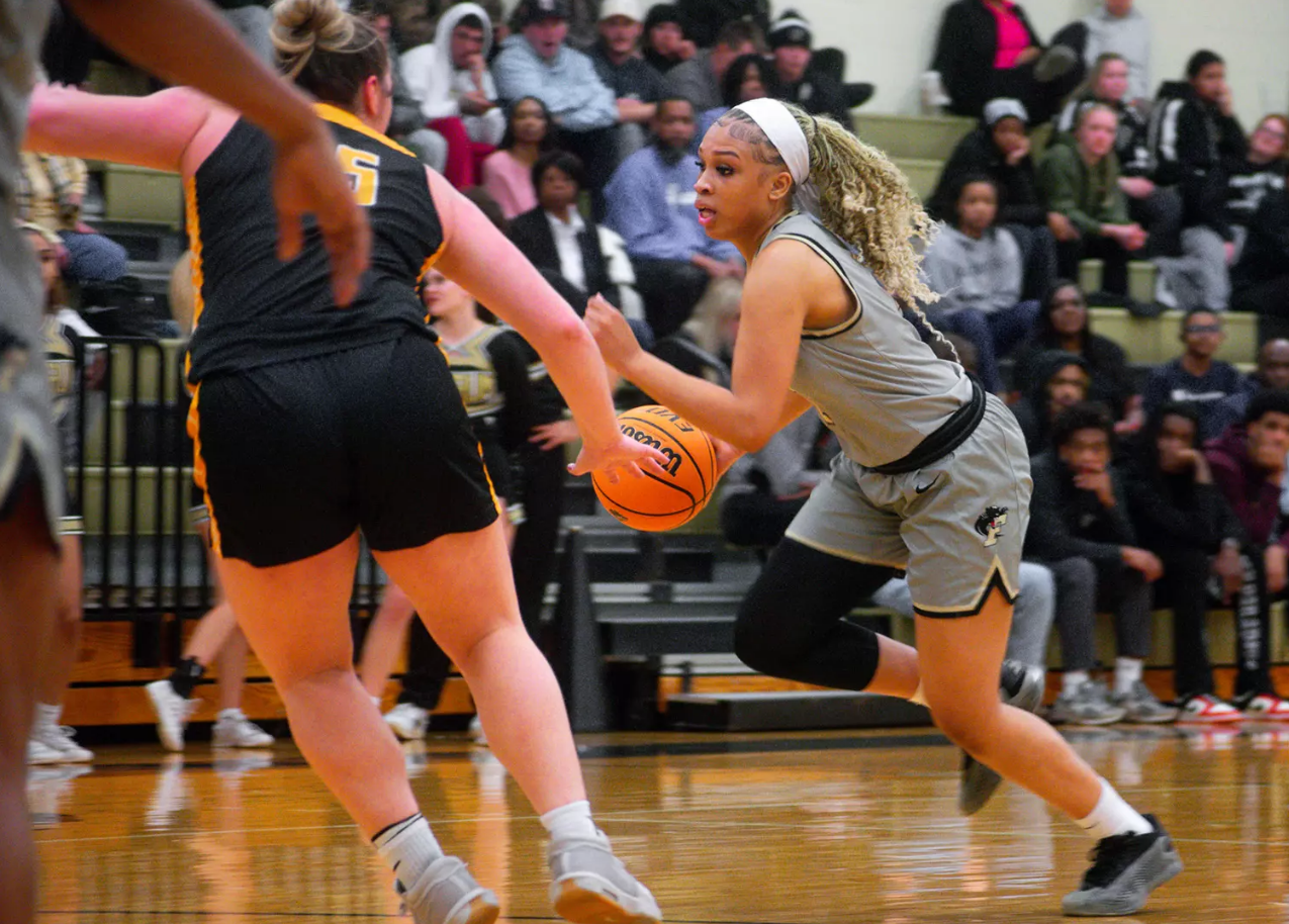 Sophomore Kleiauna Riddick dribbles towards the basket to score for the Panthers.