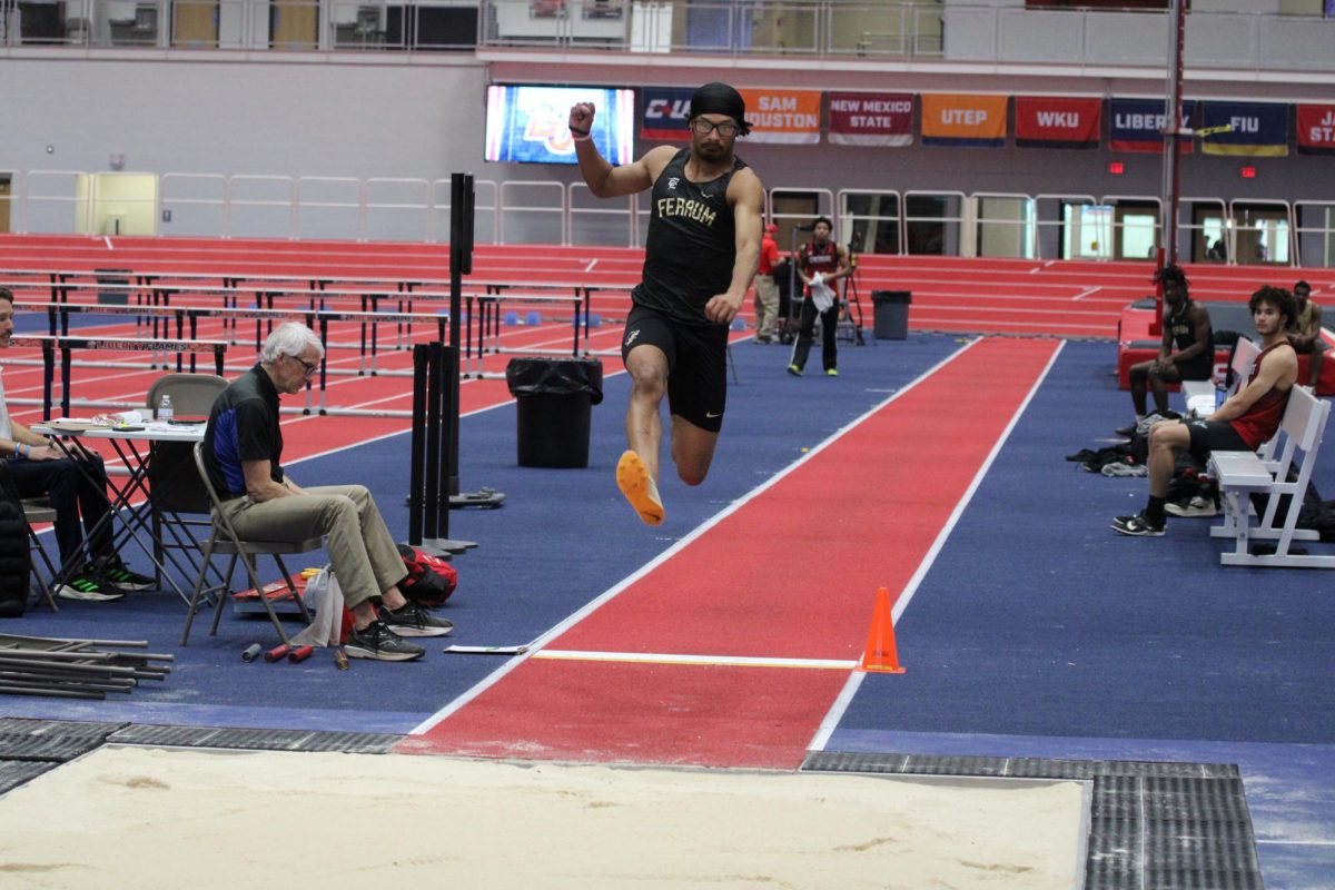  Senior Deontae Lawson mid air during long jump at Liberty.