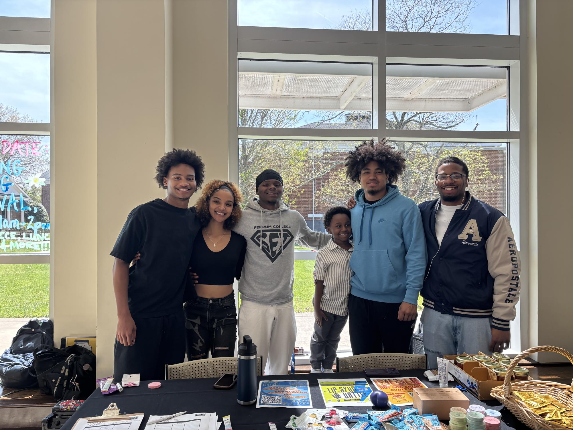 The Student Engagement Team stands behind their table on Wellness Wednesday.