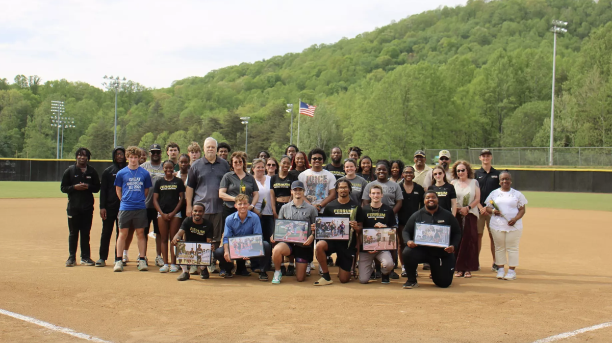 The six seniors pose with their teammates and family members prior to the softball game. 